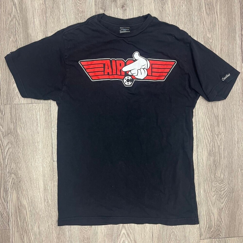 Crooks & Castles black t-shirt with red graphic of a hand pointing with wings